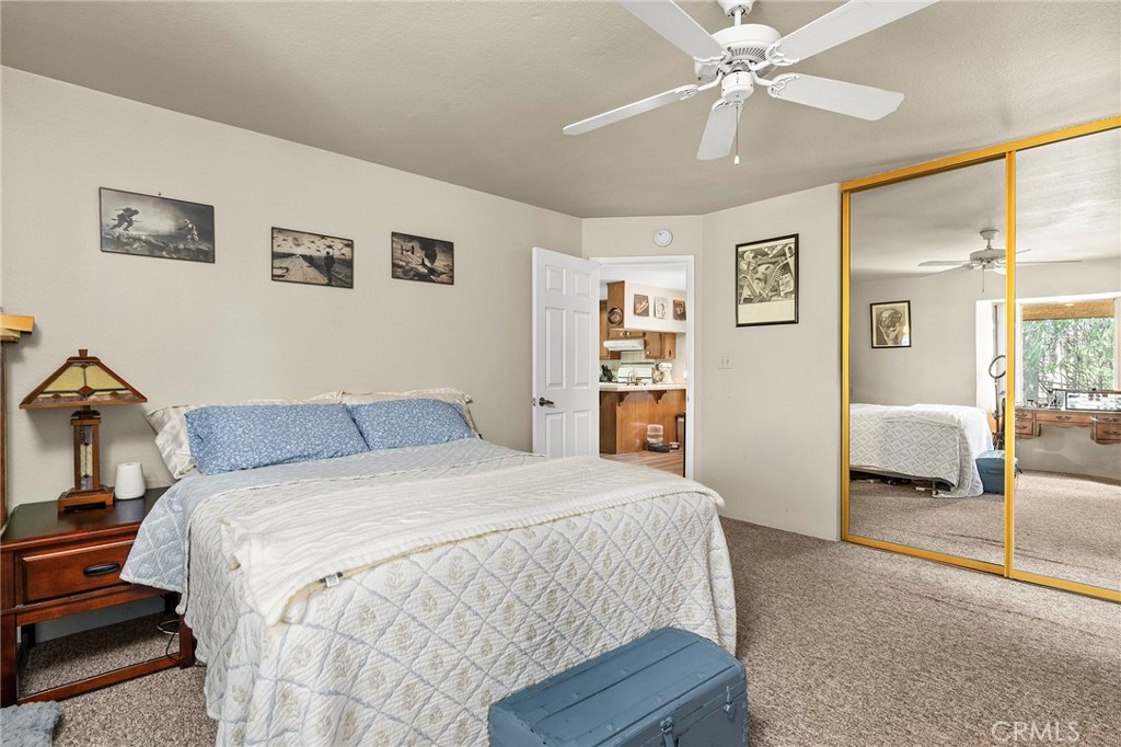 14243 Wycliff Way Magalia, CA 95954 - Photo 54 of 65 a bedroom with a large bed and a chandelier
