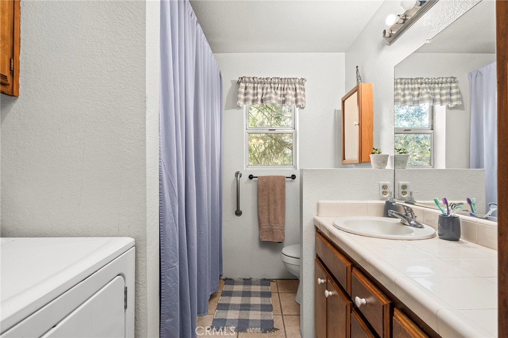 14243 Wycliff Way Magalia, CA 95954 - Photo 55 of 65 a bathroom with a sink a toilet and a window