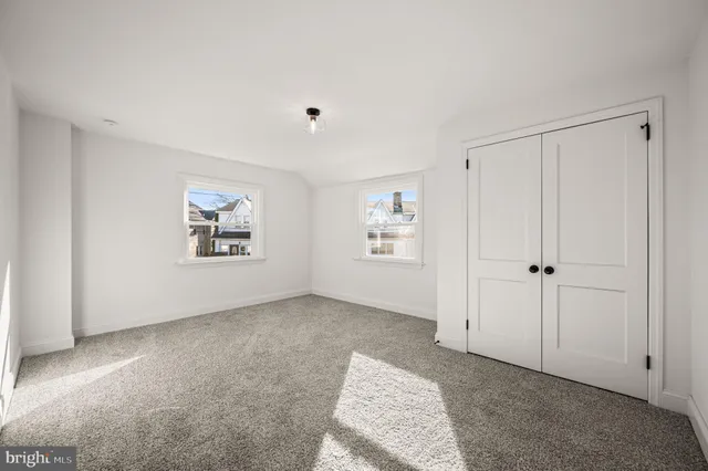 a view of an empty room with closet area