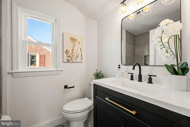 a bathroom with a toilet sink and mirror