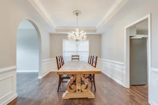 a view of a dining room with furniture and chandelier