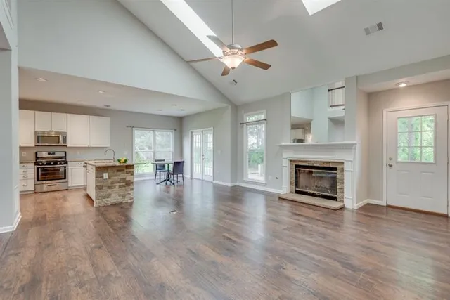 a view of a livingroom with fireplace wooden floor and a window