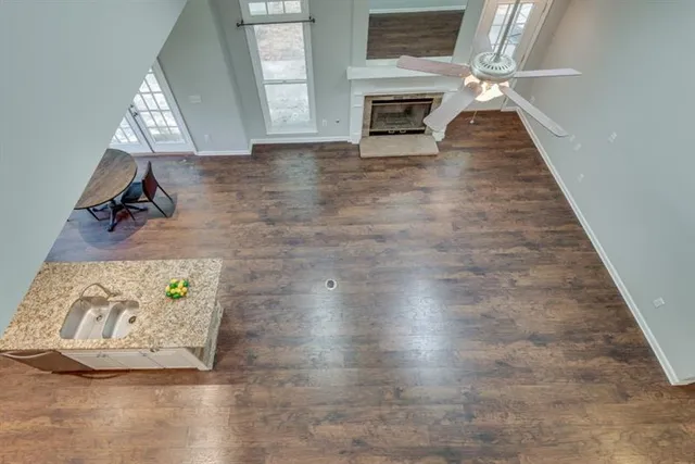 a bathroom with a granite countertop sink a toilet and a mirror
