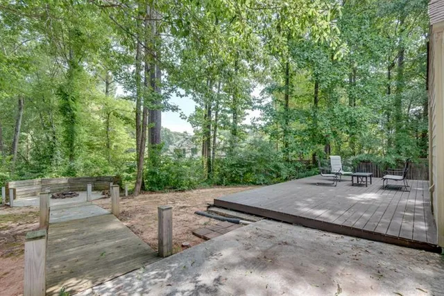 a view of a deck with table and chairs and wooden floor