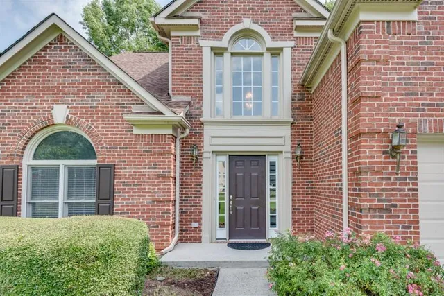 a front view of a house with a garden