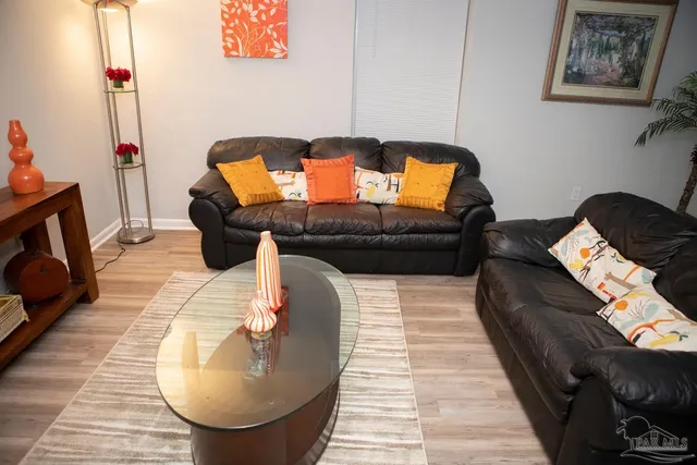 a living room with furniture and a mirror