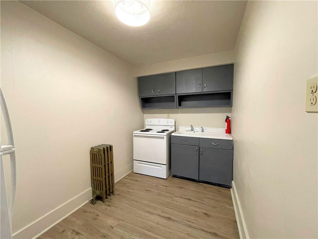 922 Hober Avenue, Unit 1 McKees Rocks, PA 15136 - Photo 2 of 5 a kitchen with a refrigerator and a stove