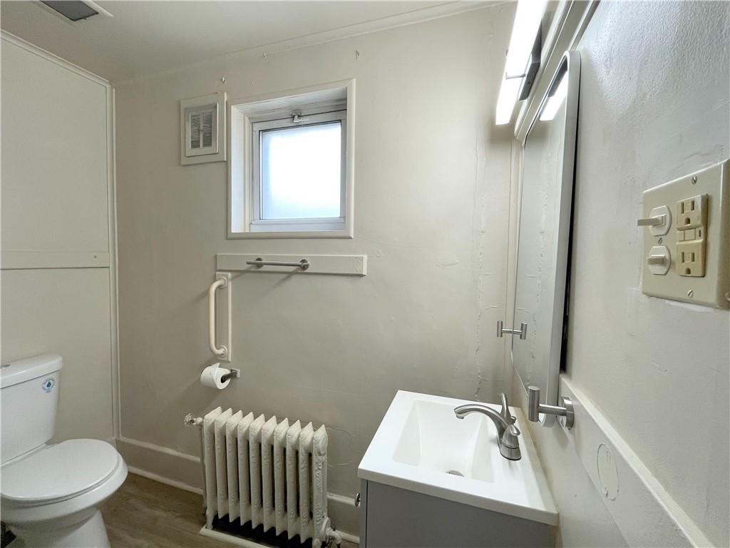 922 Hober Avenue, Unit 1 McKees Rocks, PA 15136 - Photo 4 of 5 a bathroom with a sink and a toilet