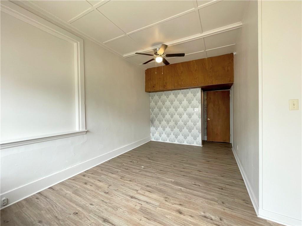922 Hober Avenue, Unit 1 McKees Rocks, PA 15136 - Photo 5 of 5 an empty room with wooden floor and cabinet