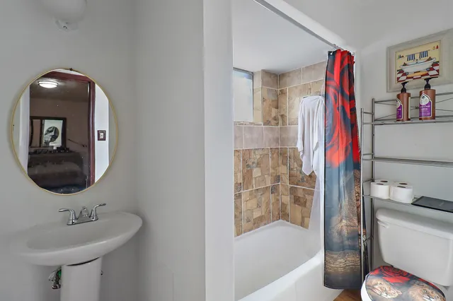 a bathroom with a sink toilet and shower