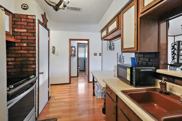 a kitchen with stainless steel appliances granite countertop a refrigerator and a sink