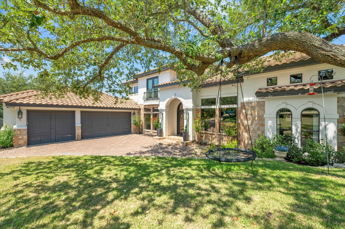 a front view of a house with a yard and garage