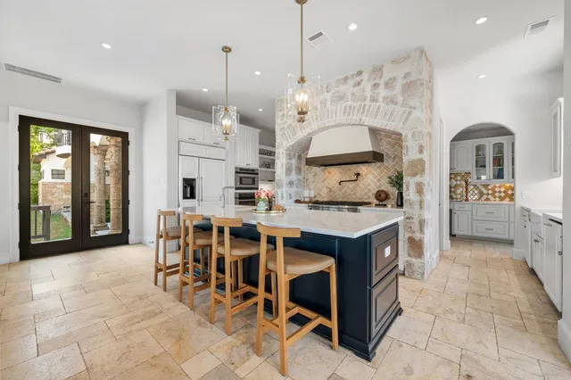 a kitchen with stainless steel appliances a refrigerator and cabinets