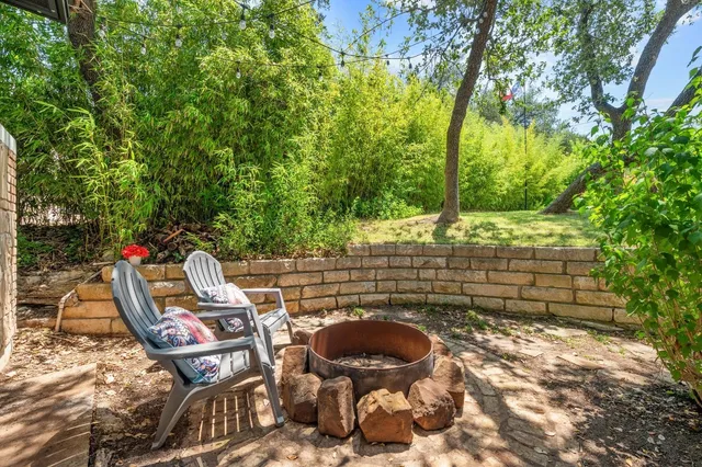 a bedroom with a bed and large windows