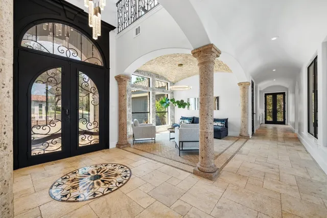 a living room with furniture and large windows