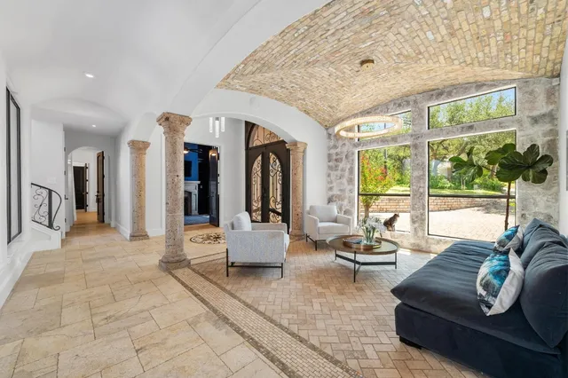 a large bedroom with furniture and a large window