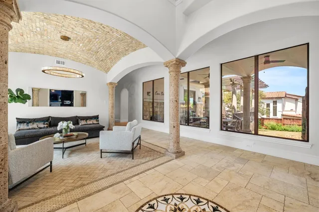 a living room with furniture and large windows