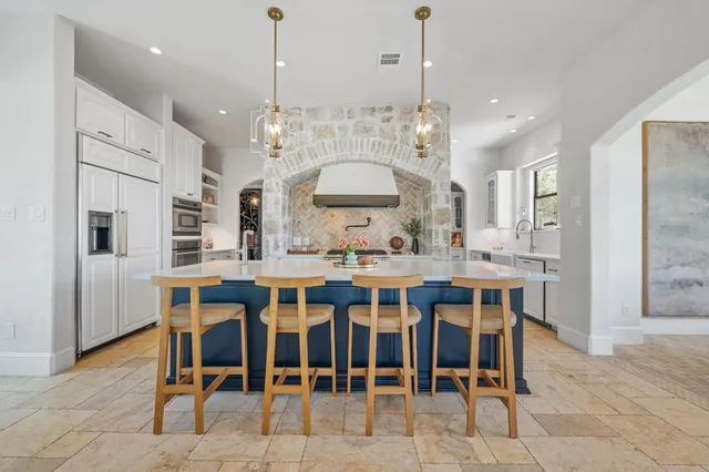 a large kitchen with a table and chairs