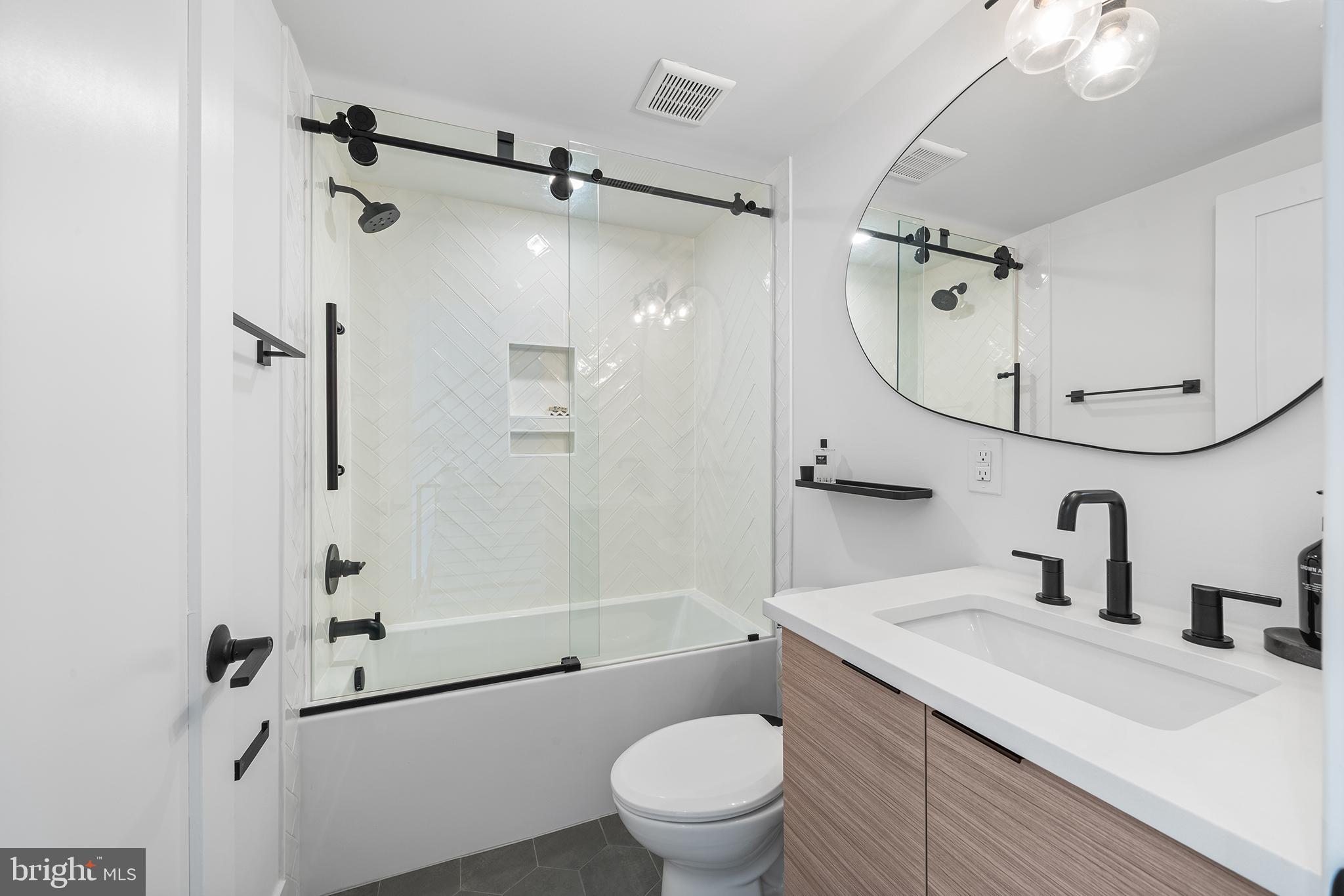 1322 Rodman Street Philadelphia, PA 19147 - Photo 27 of 38 a bathroom with a sink a mirror toilet and shower