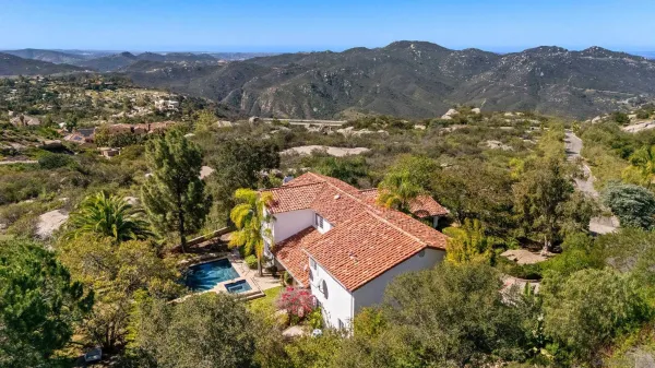 an aerial view of a house with mountain view