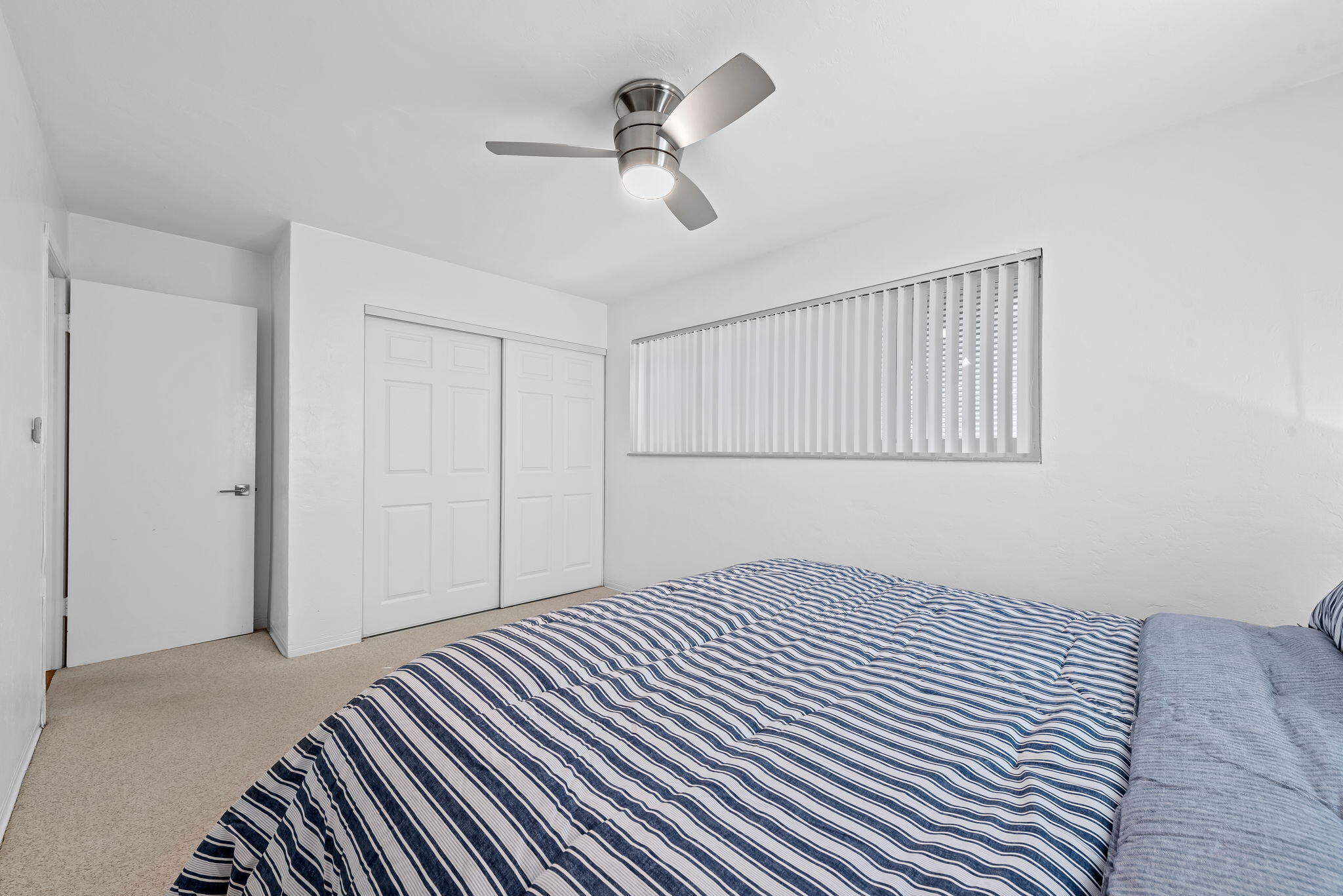 27 Northeast 16th Avenue Pompano Beach, FL 33060 - Photo 15 of 21 a bedroom with a bed and a chandelier