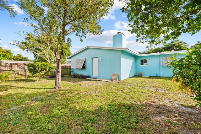 a house that has a tree in front of it