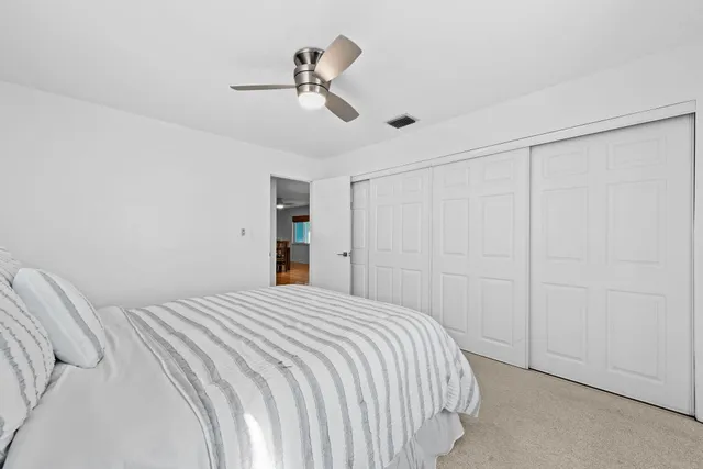 a bedroom with a large bed and a chandelier