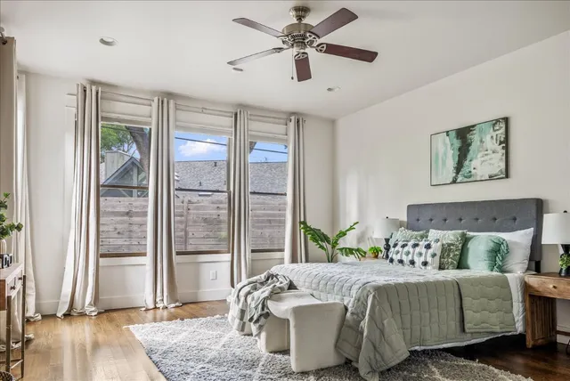 a bedroom with a bed and glass door