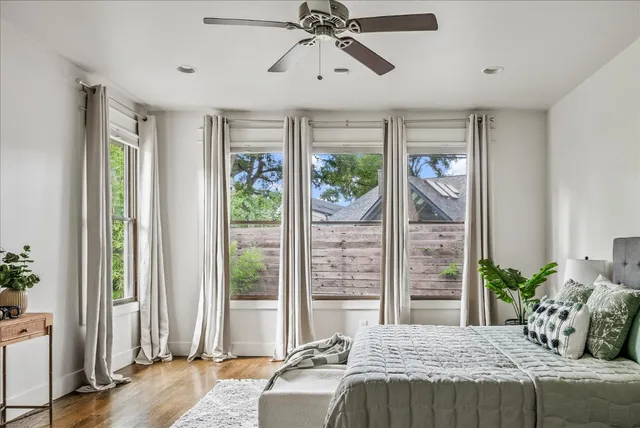 a bedroom with a balcony a bed and a window