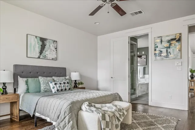 a bedroom with a bed and wooden floor