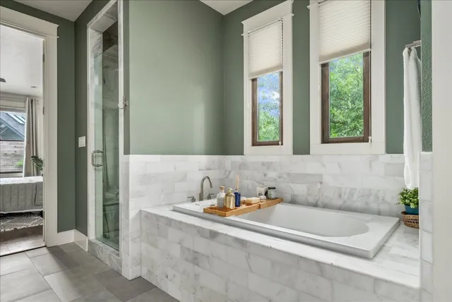 a bath tub sitting in a bathroom next to a window