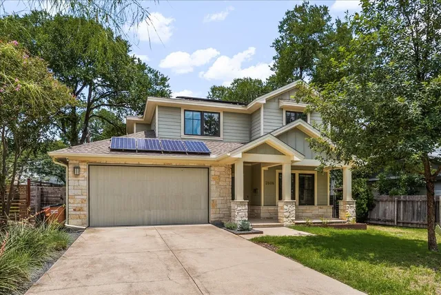 a front view of a house with a garden and porch