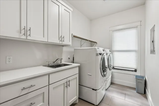 a front view of a house with a garden and trees