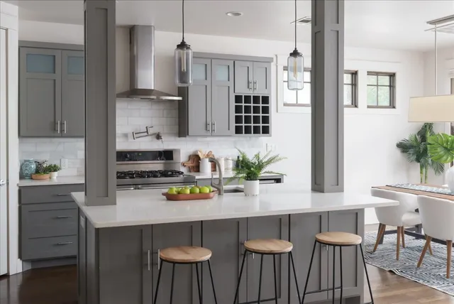 a kitchen with stainless steel appliances a table chairs refrigerator and cabinets