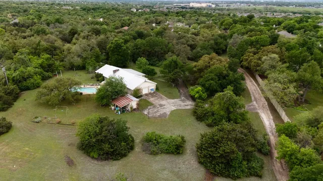 an aerial view of residential house with outdoor space and swimming pool