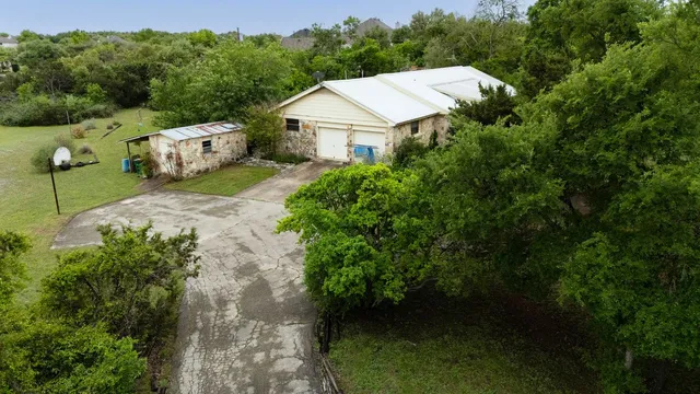 an aerial view of a house with pool yard outdoor and yard