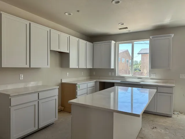 a kitchen with a sink cabinets and window