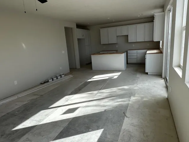 a room with a white cabinets and white appliances
