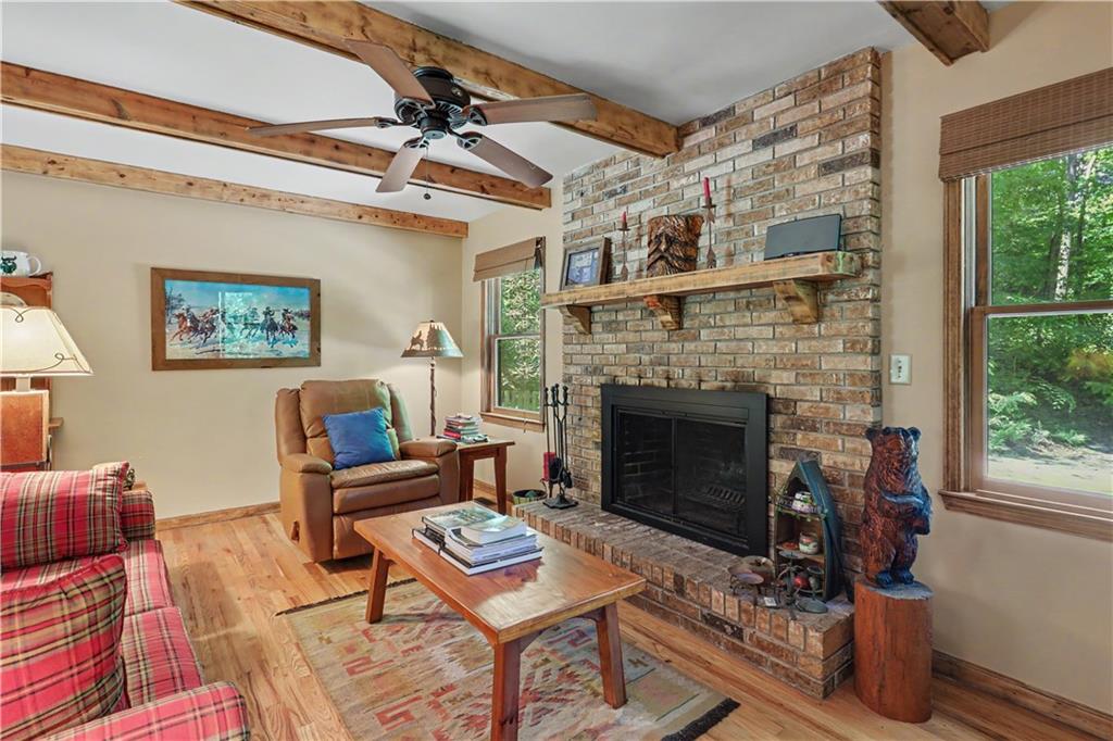 102 Moses Road Rabun Gap, GA 30568 - Photo 7 of 40 a living room with furniture and a fireplace
