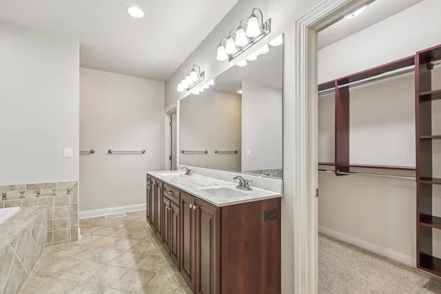 a bathroom with double sink and a mirror