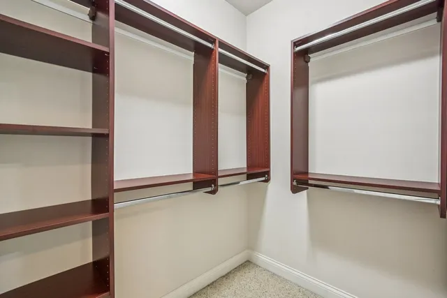 an empty room with entrance and windows