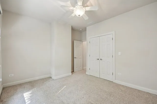 a view of a backyard with table and chairs and wooden fence