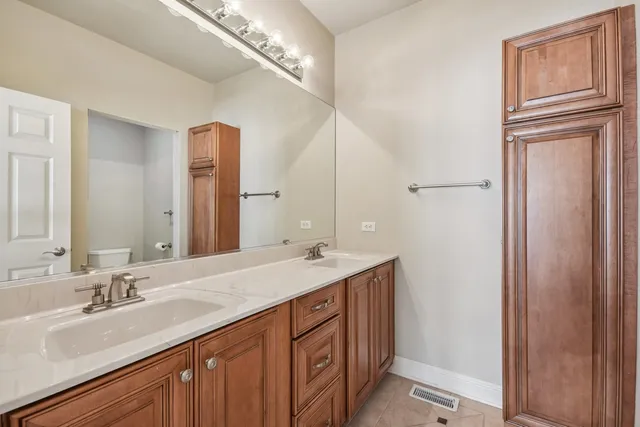 an aerial view of a house with swimming pool and large trees