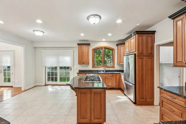 a kitchen with stainless steel appliances granite countertop a stove and a refrigerator