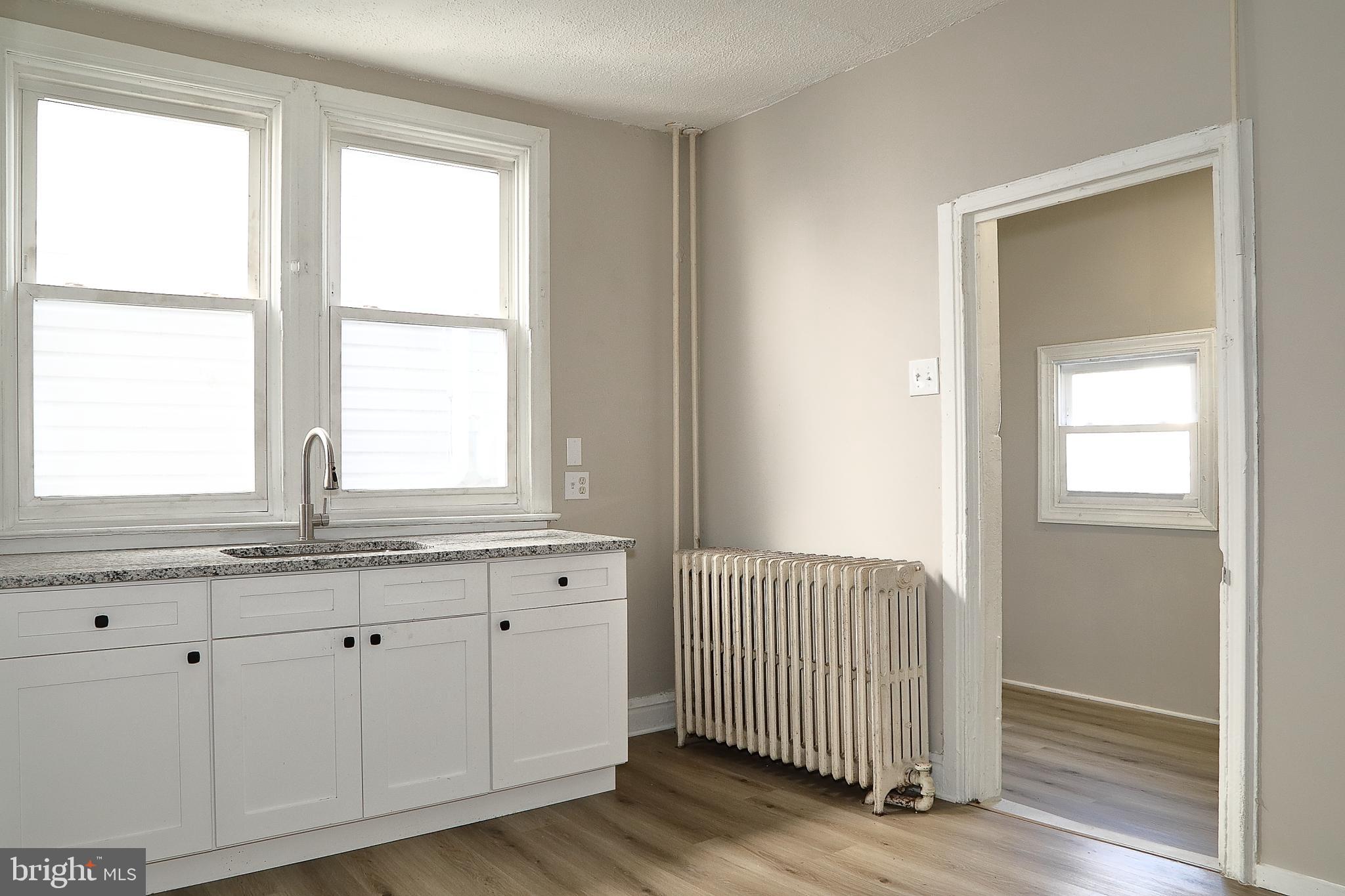 875 East Prospect Street York, PA 17403 - Photo 11 of 21 a view of a kitchen with granite countertop white cabinets and a window