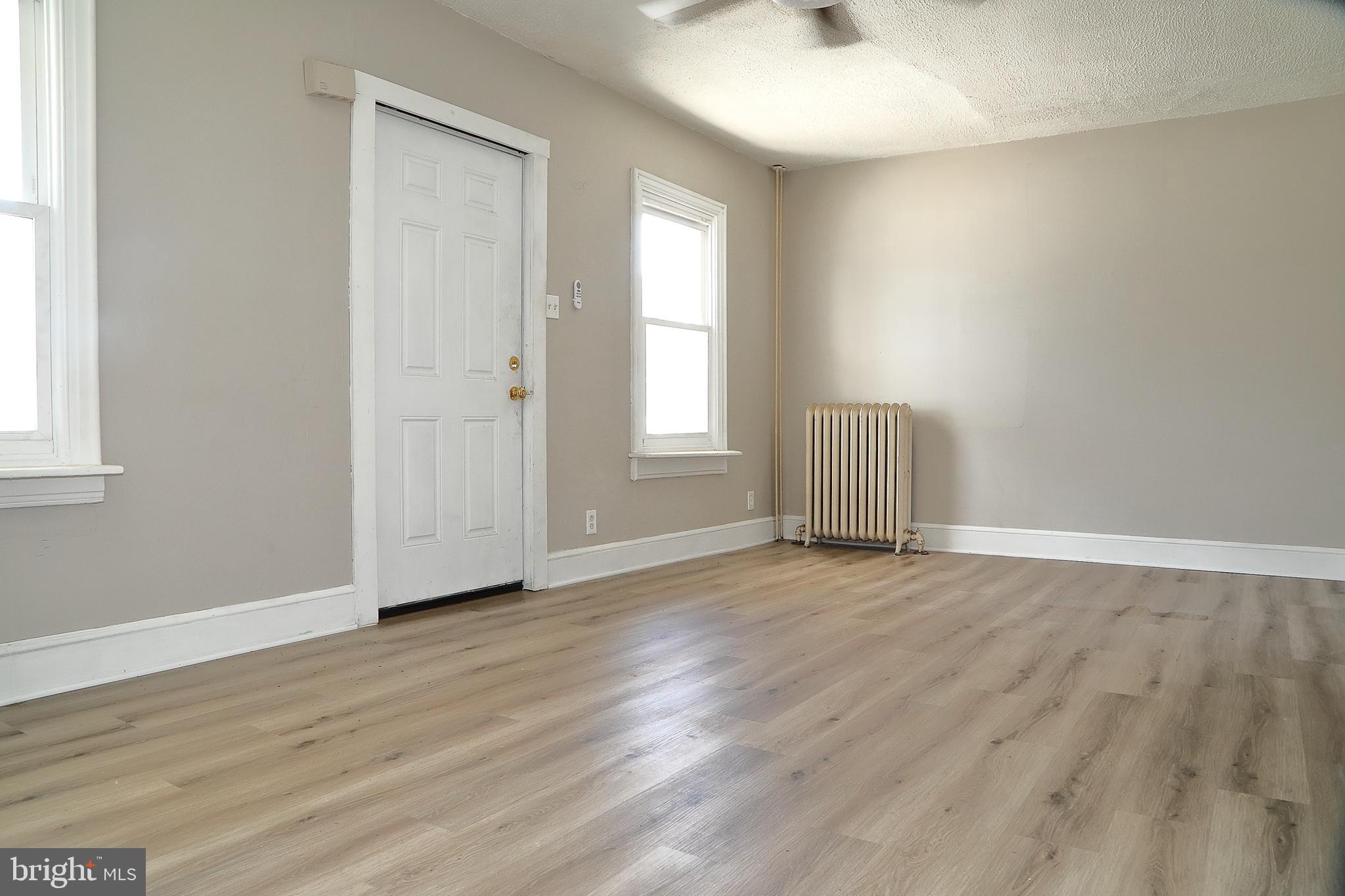 875 East Prospect Street York, PA 17403 - Photo 2 of 21 an empty room with wooden floor and windows