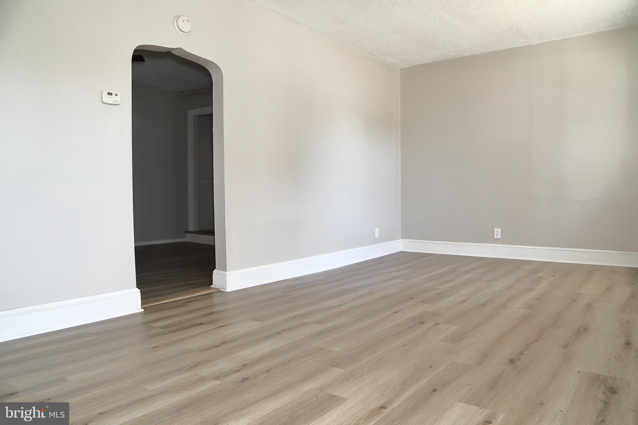 875 East Prospect Street York, PA 17403 - Photo 4 of 21 a view of an empty room with wooden floor and a window