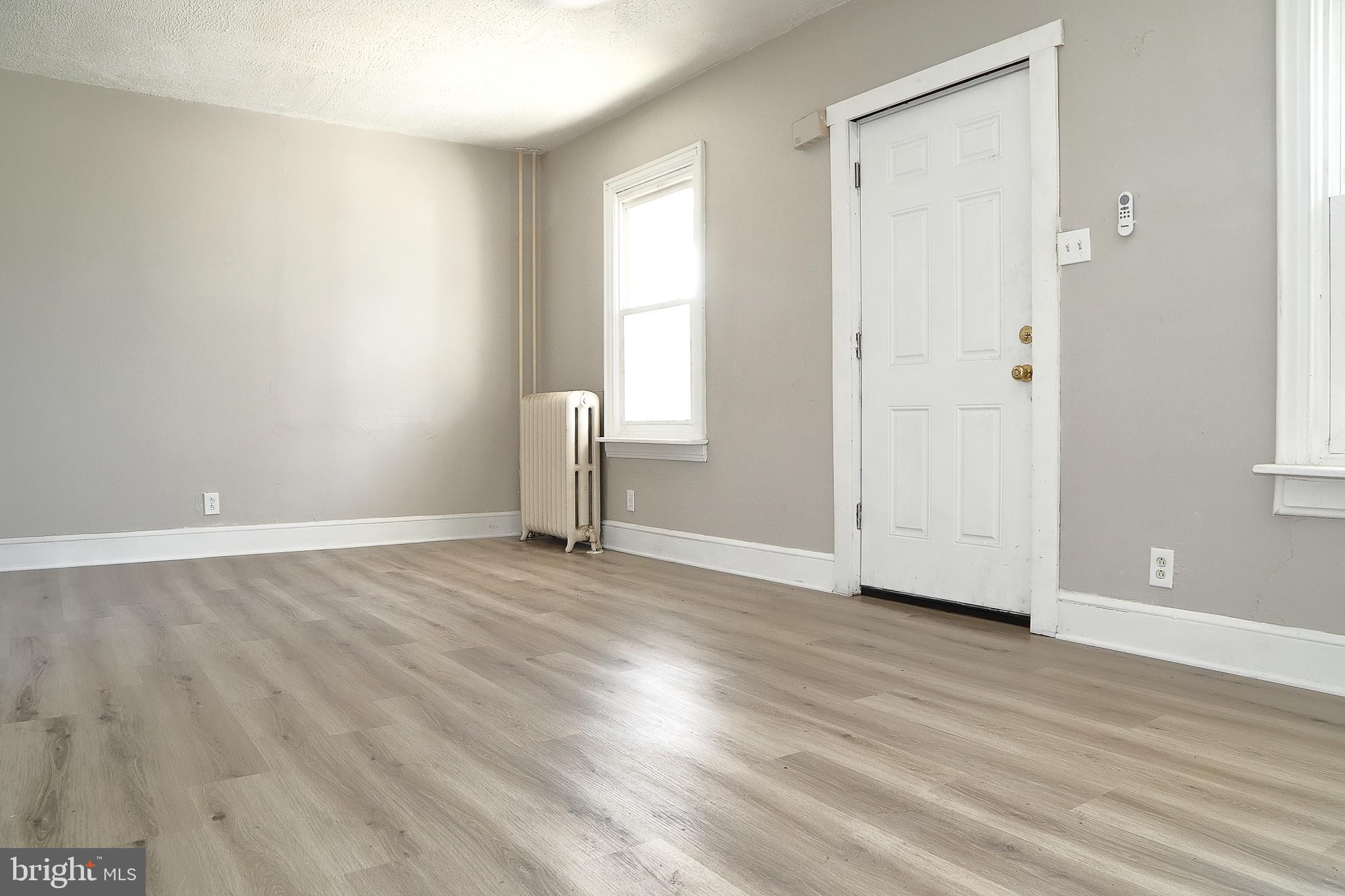 875 East Prospect Street York, PA 17403 - Photo 5 of 21 an empty room with wooden floor and windows