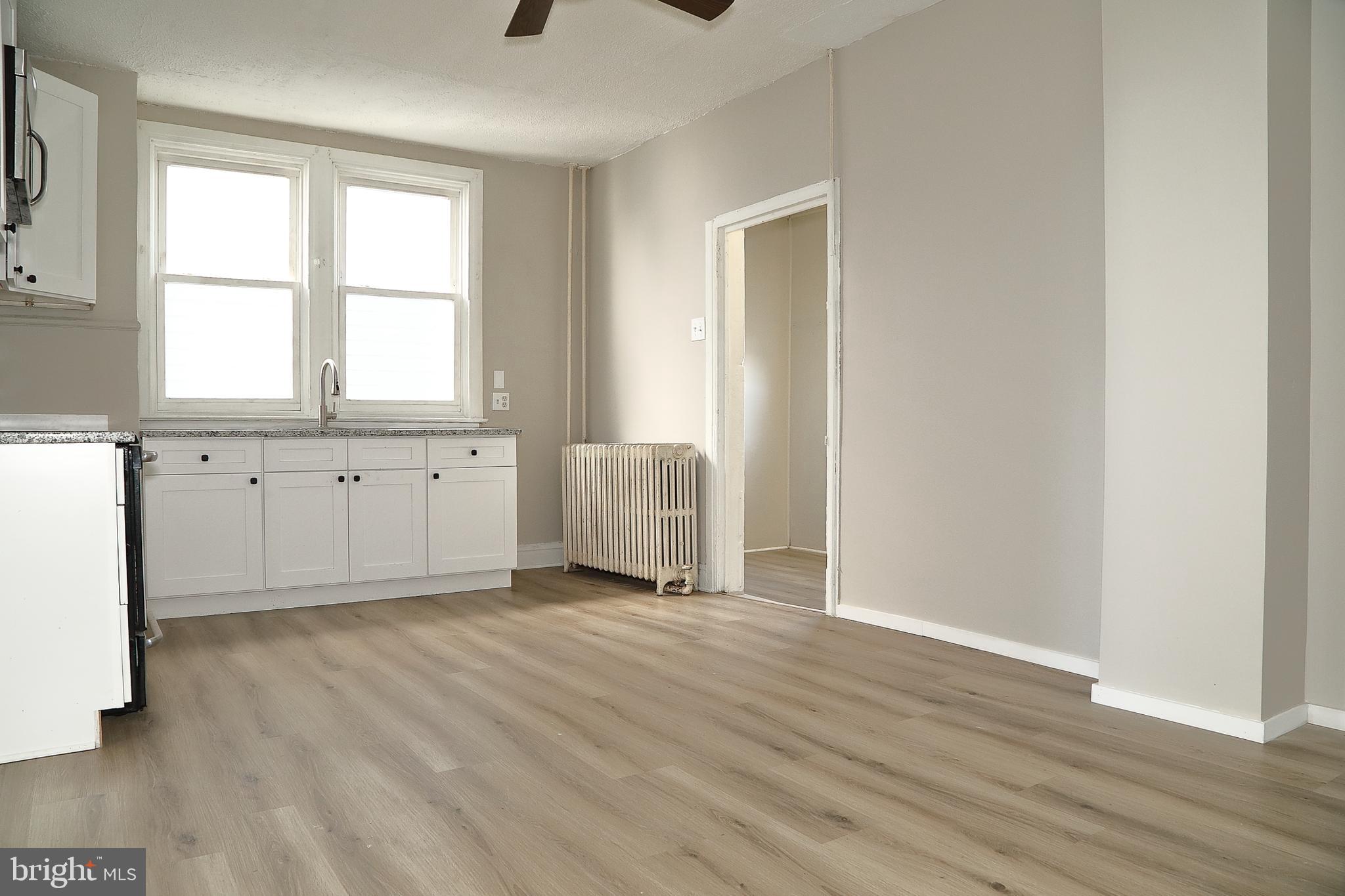 875 East Prospect Street York, PA 17403 - Photo 8 of 21 an empty room with wooden floor and windows