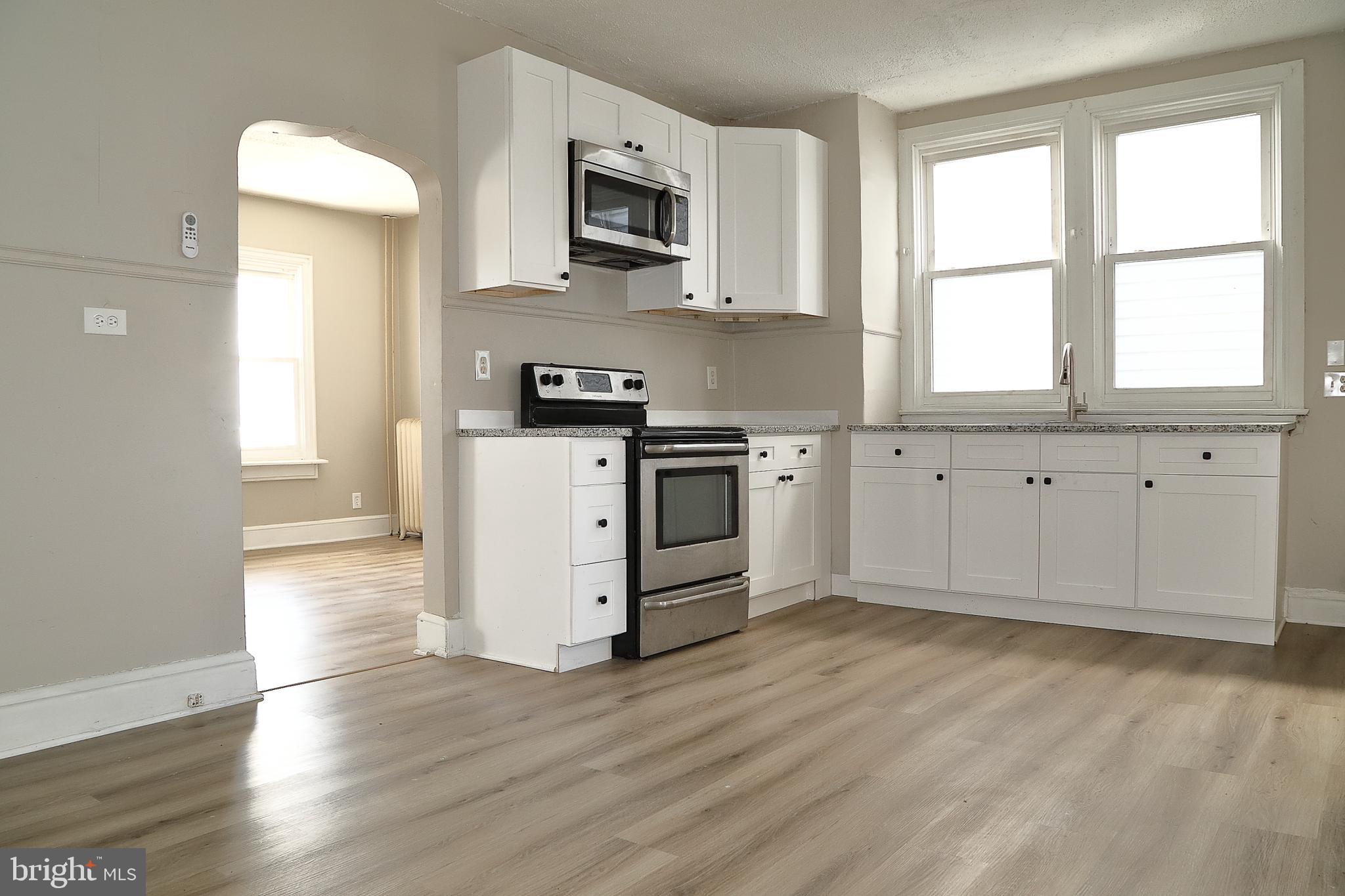875 East Prospect Street York, PA 17403 - Photo 9 of 21 a kitchen with stainless steel appliances granite countertop a stove a sink and a microwave